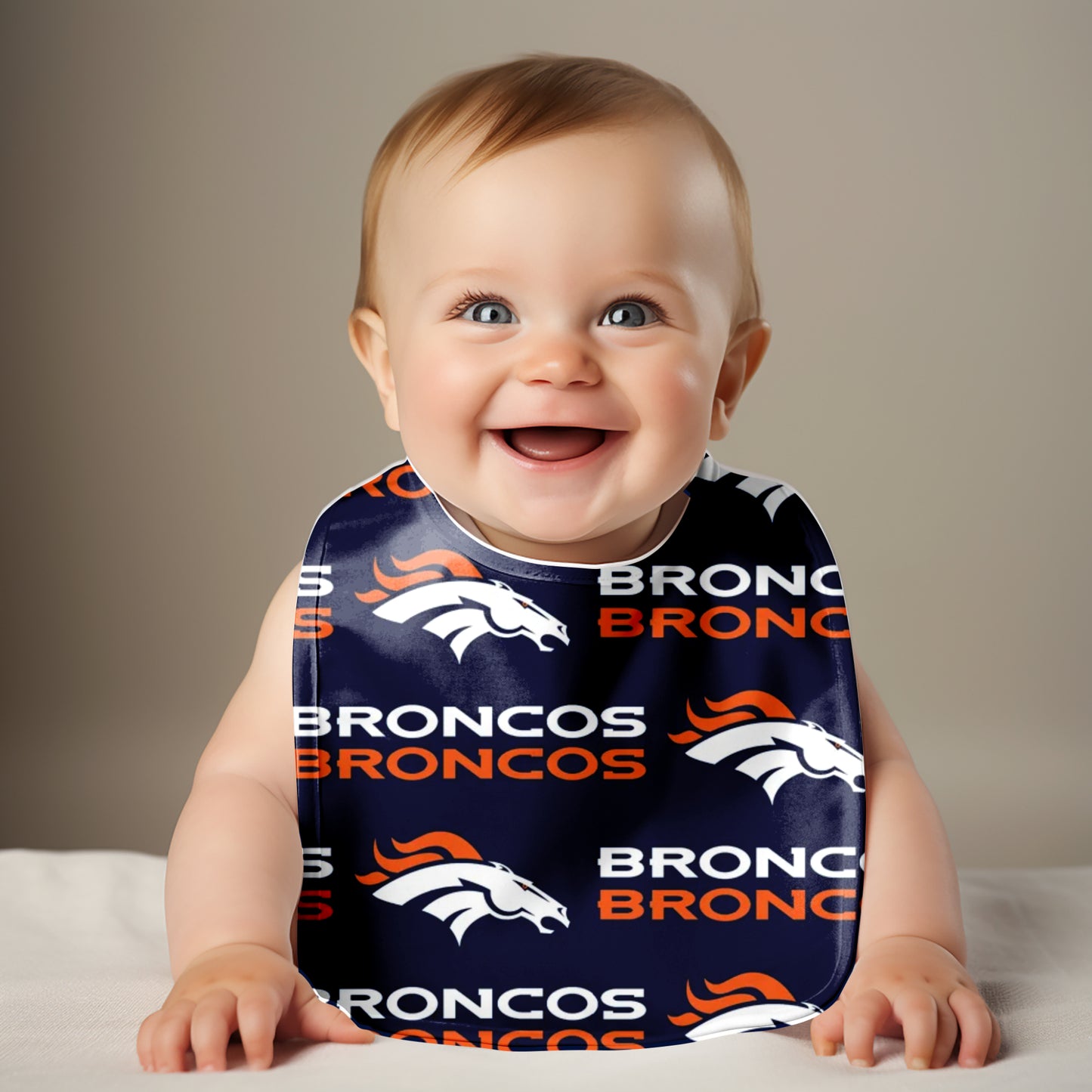 Smiling Baby Wearing Broncos Traditional Bib