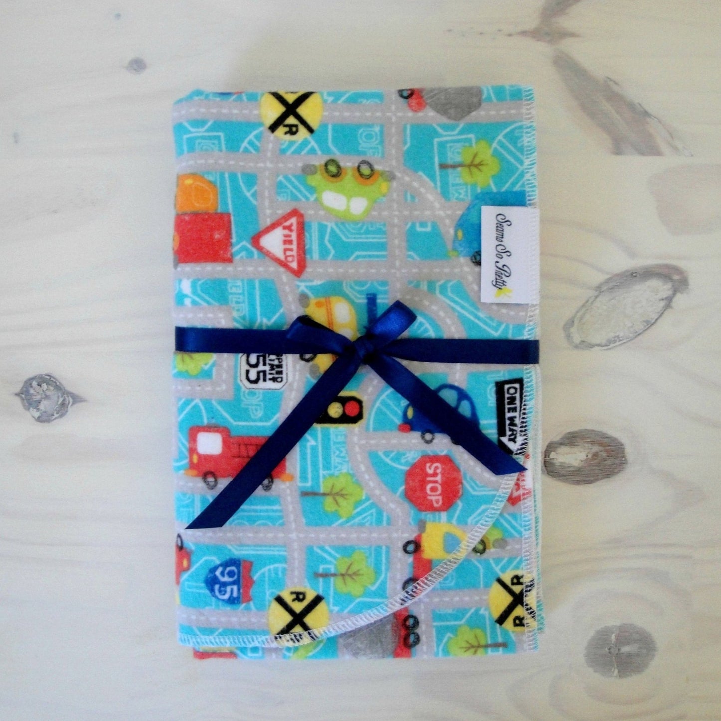 Cars, trucks and Road Signs flannel receiving blanket tied with blue ribbon bow