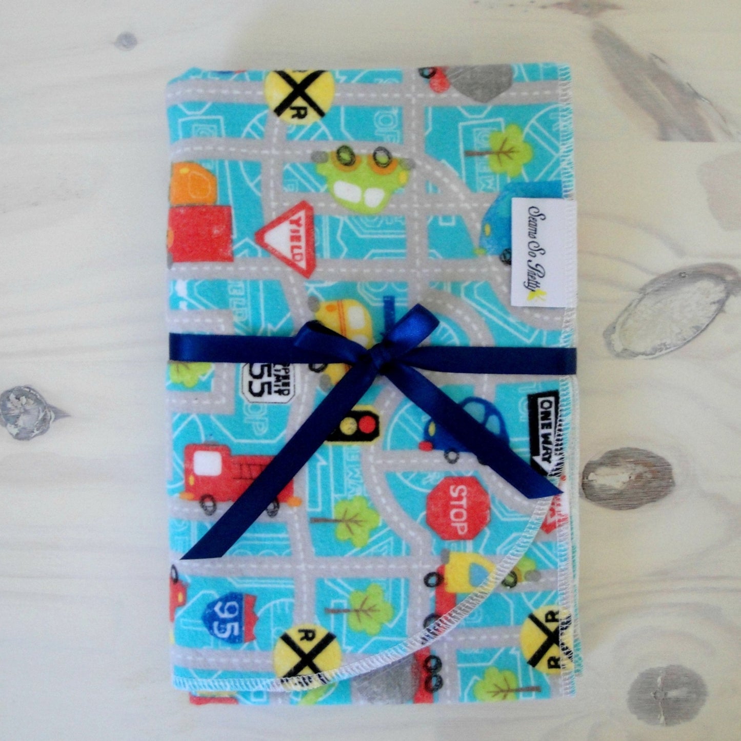 Cars, trucks and Road Signs flannel receiving blanket tied with blue ribbon bow