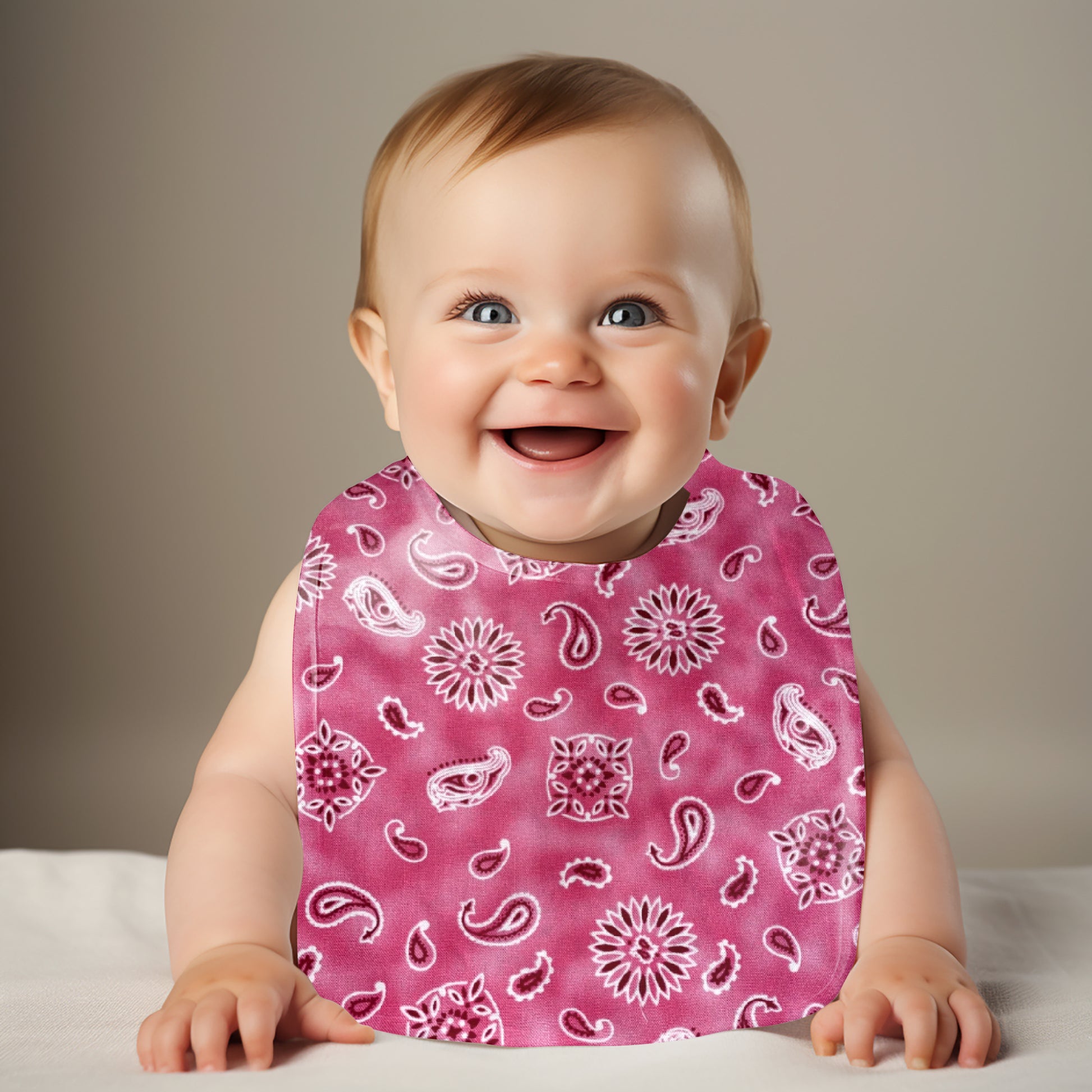 Smiling Baby Wearing Pink Paisley Traditional Bib
