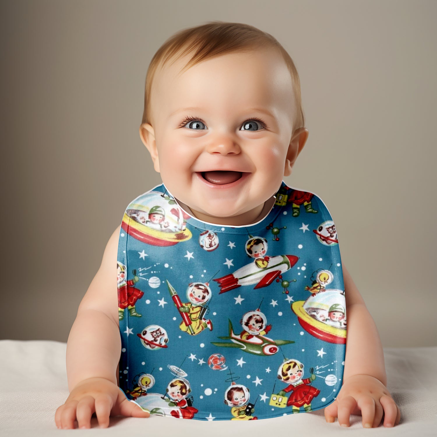 Smiling baby wearing Retro Rockets Rascals Bib