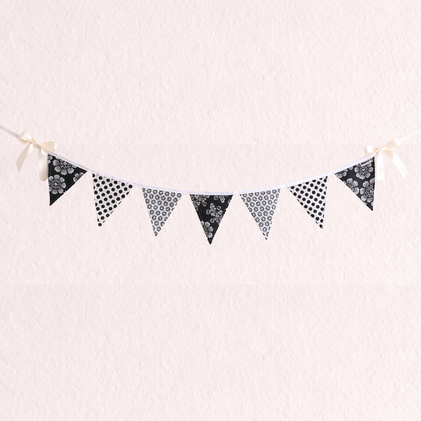 Black and white floral and polka dot fabric bunting banner with scalloped zig zag edges and cotton binding nursery wall decor