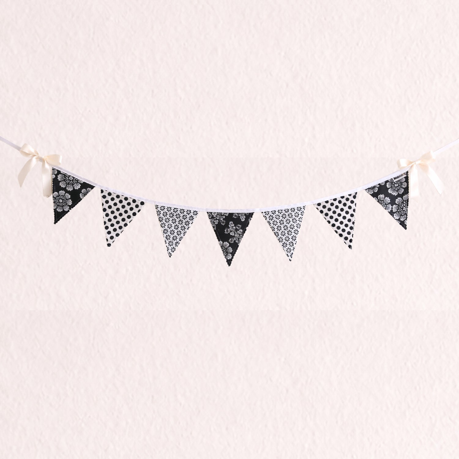 Black and white floral and polka dot fabric bunting banner with scalloped zig zag edges and cotton binding nursery wall decor
