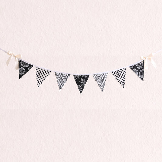 Black and white floral and polka dot fabric bunting banner with scalloped zig zag edges and cotton binding nursery wall decor