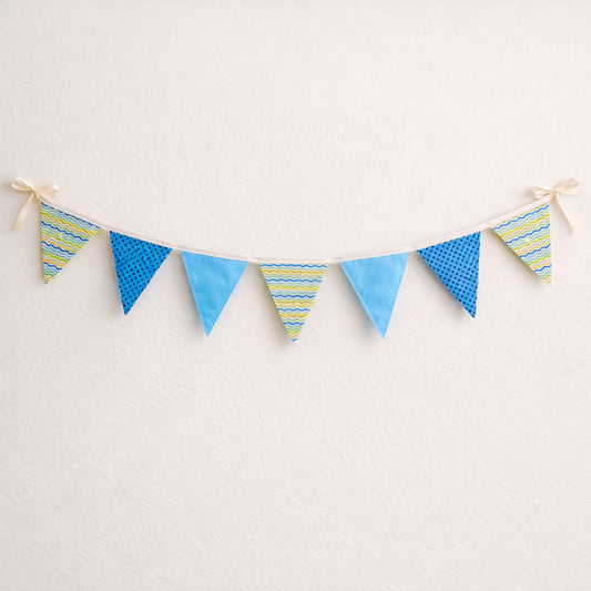 Blue fabric bunting banner with zig zag stitched flags and cotton bias binding for baby nursery decor