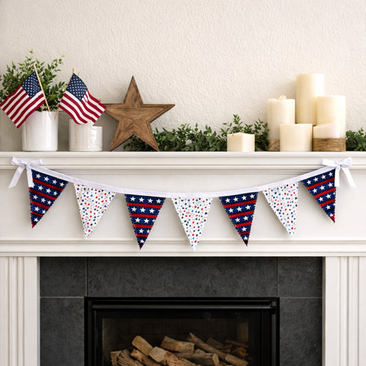 Patriotic fabric bunting banner with seven flags draped across fireplace mantel with American flags and candles for Fourth of July decor