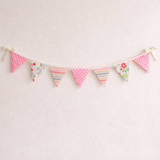 Pink floral and chevron bunting flags with polka dot accents and cream ribbon bows, nursery wall decor banner