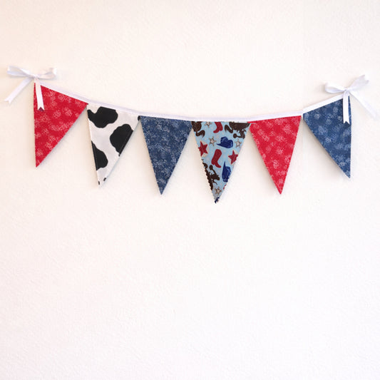 Western cowboy fabric bunting banner with bandana, cow print and paisley flags hanging on neutral wall  large