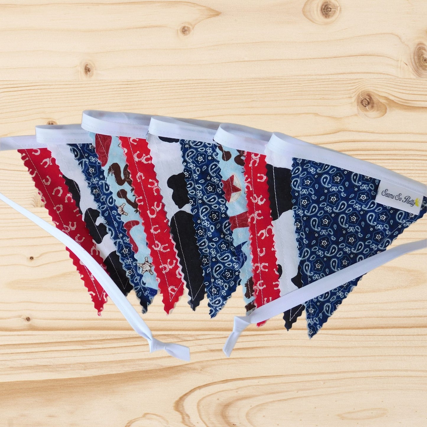 Folded western-inspired fabric bunting flag banner showing mixed cotton prints and stitched edges