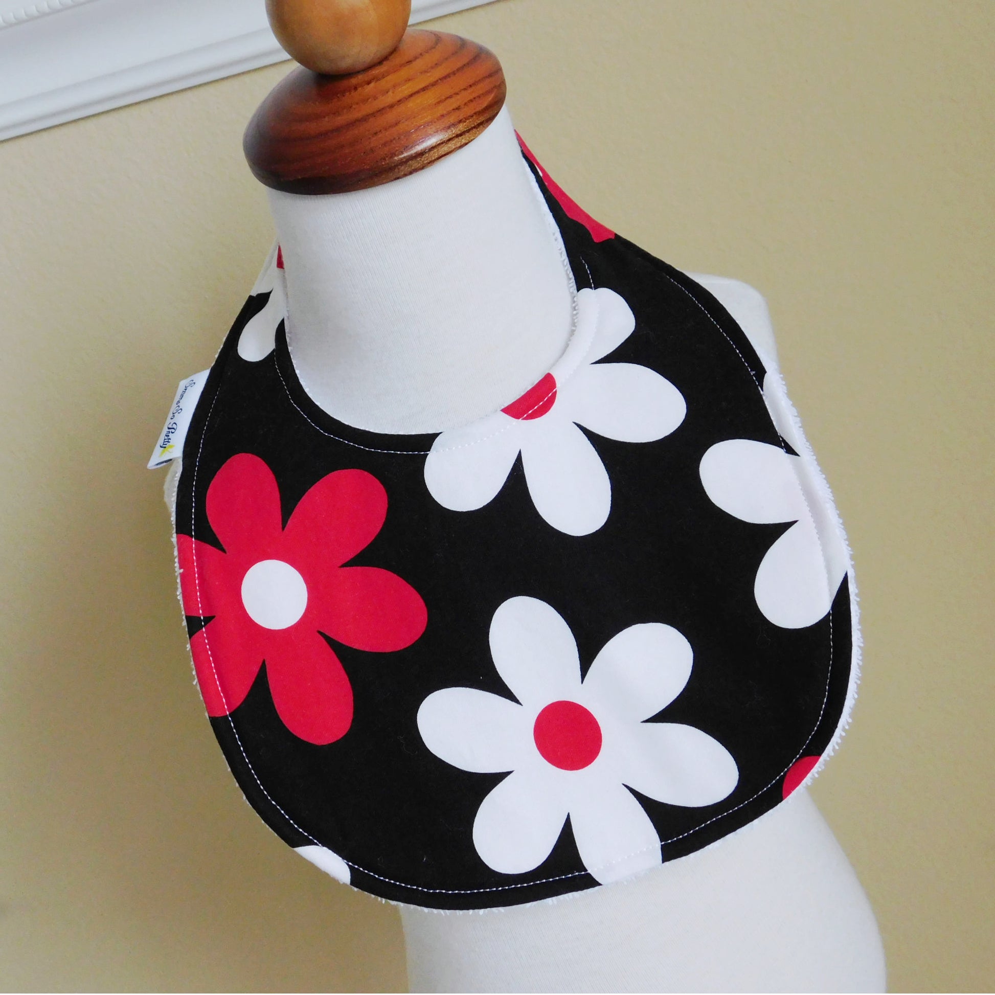 Red and White Daisy Bib Displayed on Form