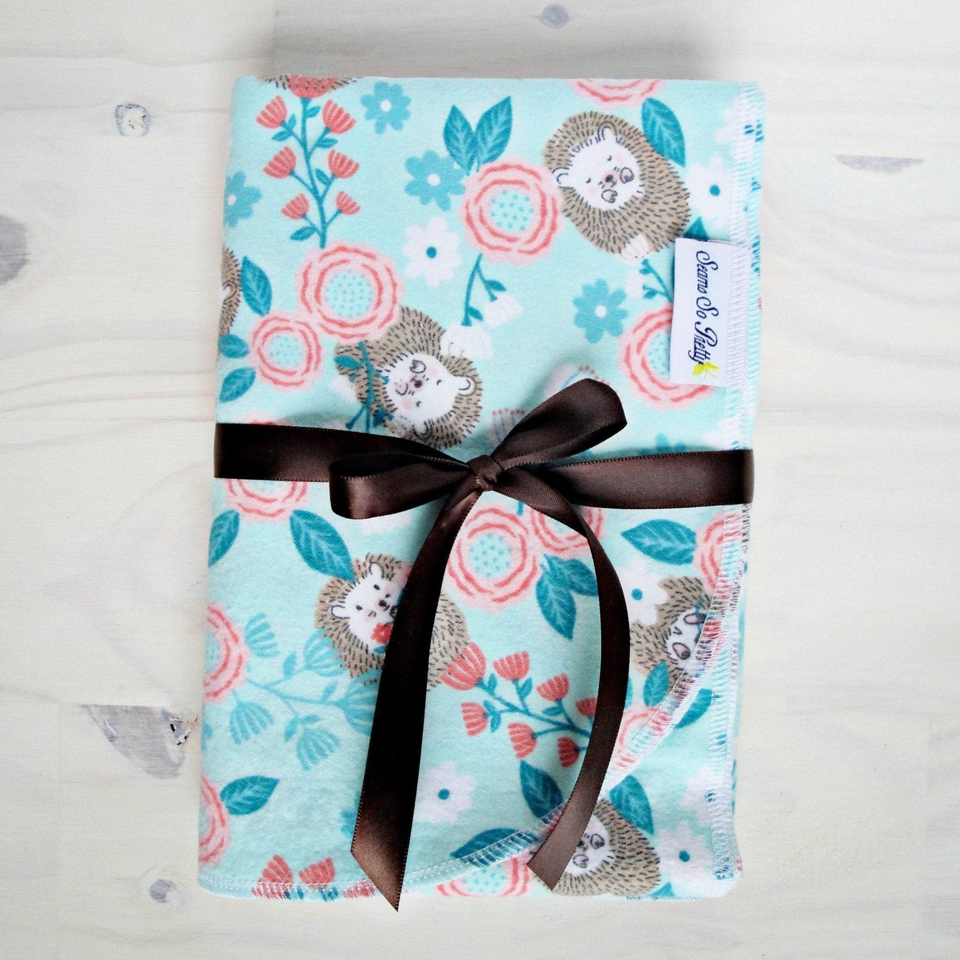Baby Hedgehog Floral Flannel Receiving Blanket Packaged with brown ribbon