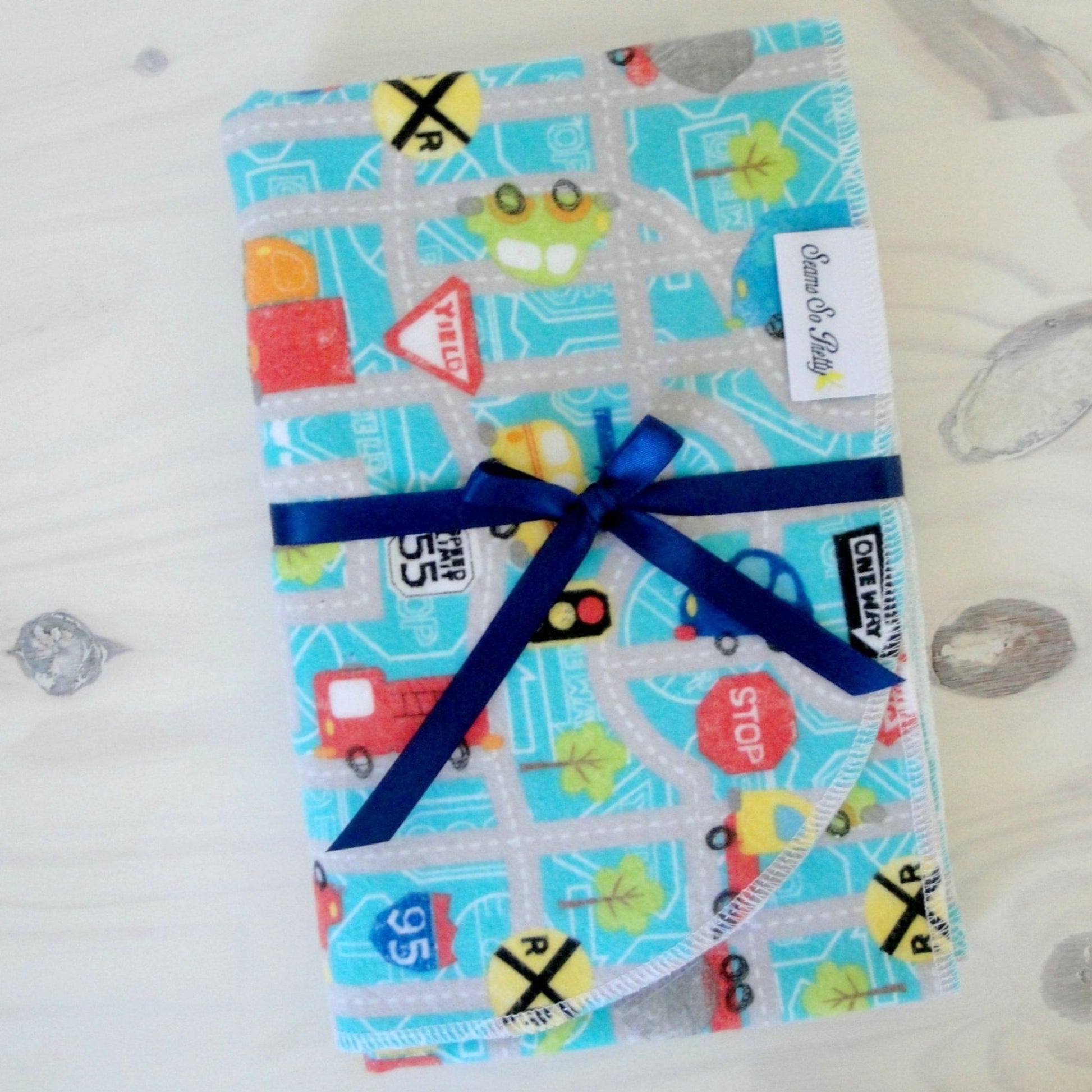 Cars, trucks and Road Signs flannel receiving blanket tied with blue ribbon bow