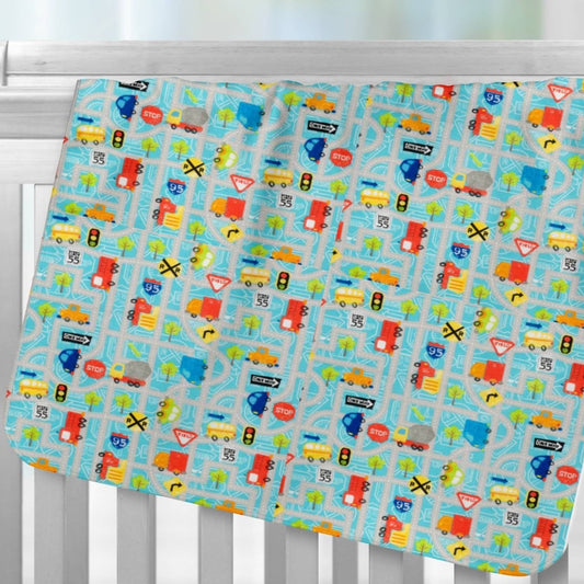 Cars, trucks and Road Signs flannel receiving blanket hanging over crib rail