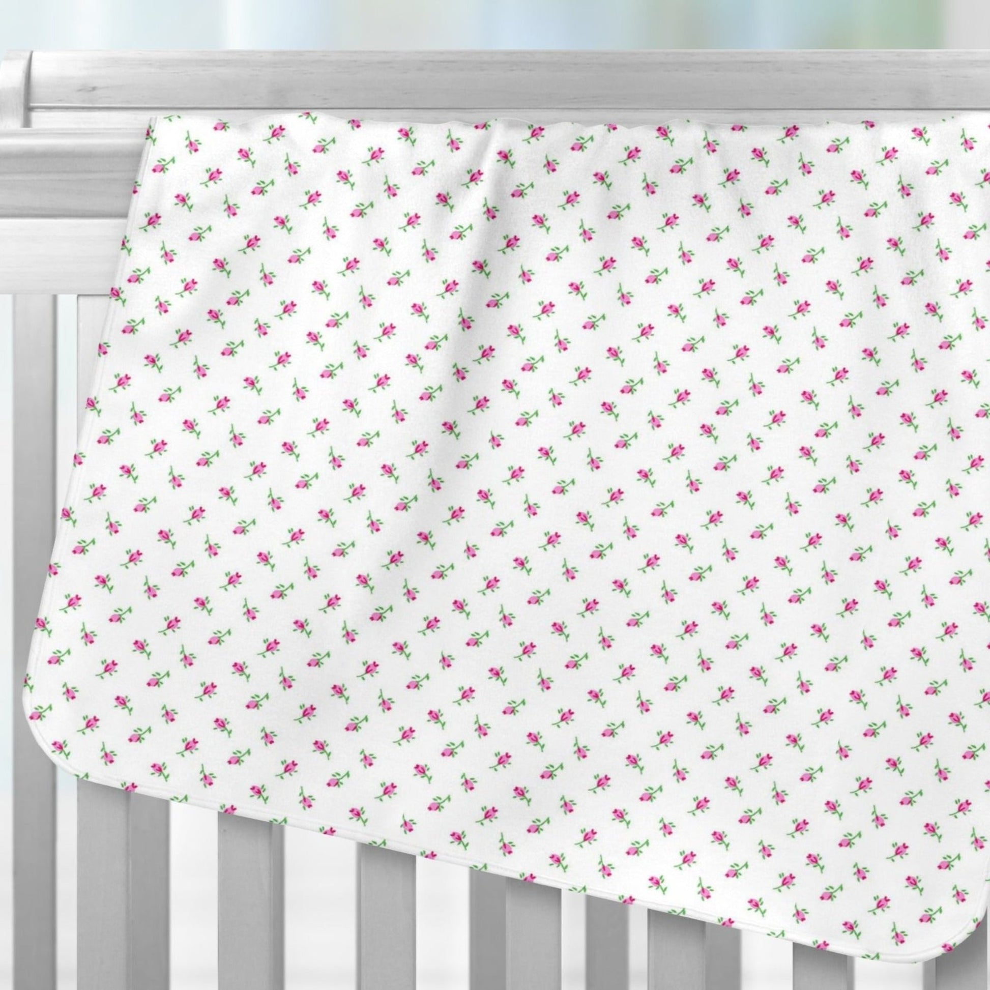 Tiny Pink Rosebuds Recieving Blanket over Crib Rails