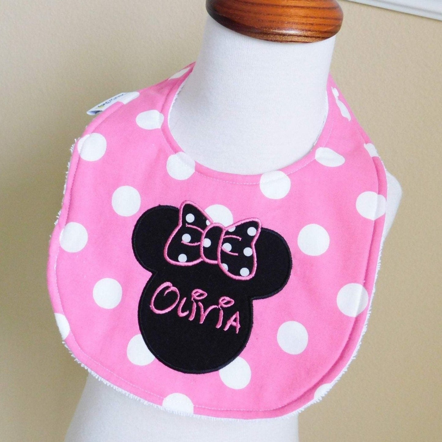 Minnie Mouse Pink Personalized Bib on Display