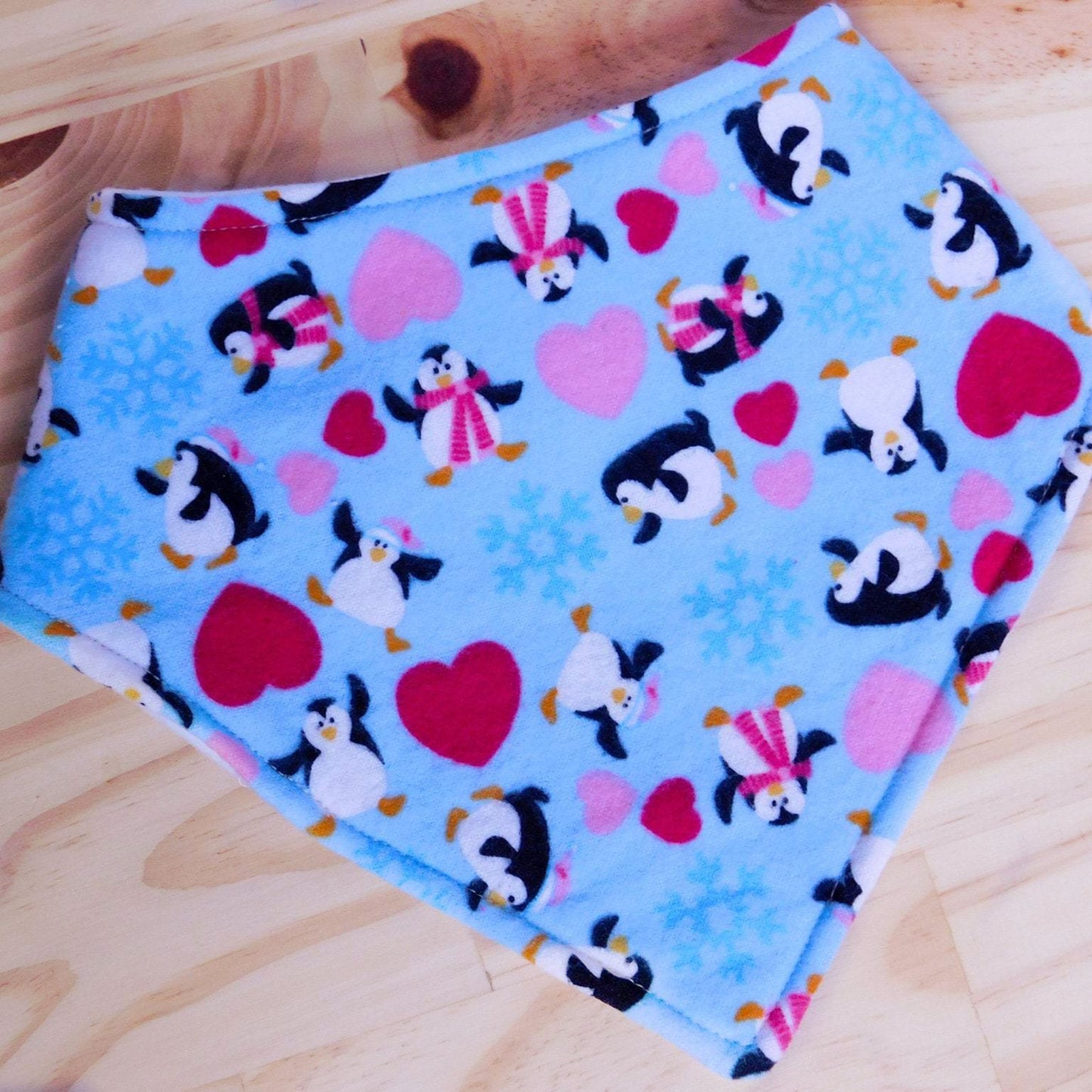 Baby Penguins and Hearts Drool Bib Front, shown snapped.