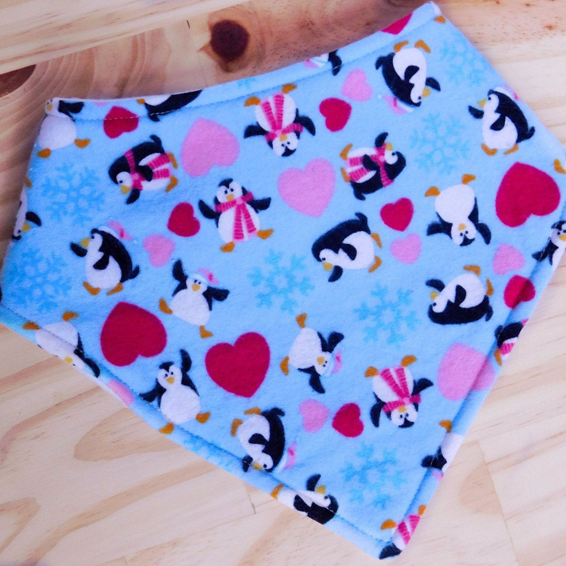 Baby Penguins and Hearts Drool Bib Front, shown snapped.